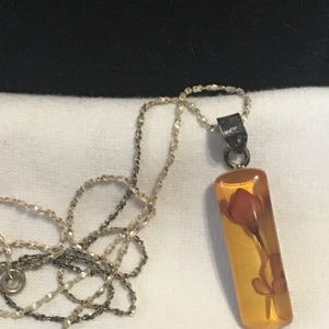 Mini rose set in sterling silver pendant.